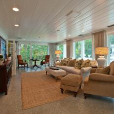 Sun Porch Style Living Room With Ample Natural Lighting and Cozy, Cushioned Seating 