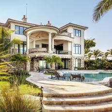 Lavish Tropical Home Exterior With In Ground Pool and Spacious Covered Balcony 