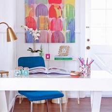 Stylish Home Office With Metallic Desk Lamp and Colorful Modern Painting