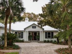 Crisp white shake siding with contrasting black trim gives this approximately 3,200-square-foot home in St. Simons Island, Georgia a strong presence and pleasing curb appeal.