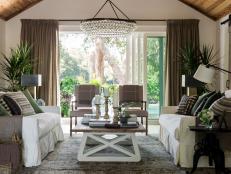 Soaring wood ceilings and walls of sliding glass doors define this central gathering space, where Southern style makes a sophisticated statement.