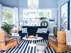 A chic lounge, wet bar, and bathroom bathed in blue hues create the perfect space for indoor and outdoor entertaining. 