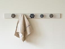 Old spigot handles are repurposed to make this charming towel rack that brings function and personality to any bathroom. 