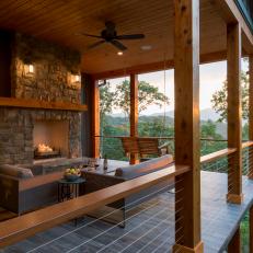 Rustic Porch With Fireplace and Swing