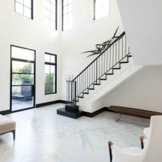Two-Story Entryway is Sleek Black and White