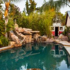 Stone Slide Leads Into Tropical Pool