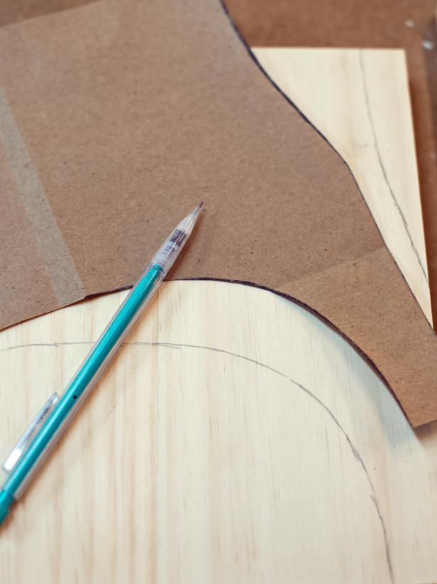 Cut a piece of brown paper to same dimension as wood pieces cut for the legs (9 wide x 10.5” high). Draw desired leg shape on half of paper, fold over and cut. This way, the template sides are symmetrical. Trace template onto two 9 x 10.5” pieces of wood cut for legs. Tip: It’s just paper!  If a mistake is made, just throw it away and start over.