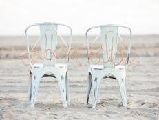 Two Metal Chairs With Copper Bride and Groom Signs