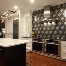 Floral Tile Backsplash in Contemporary Kitchen With Black and White Kitchen Island, Stainless Steel Fixtures and Double Oven