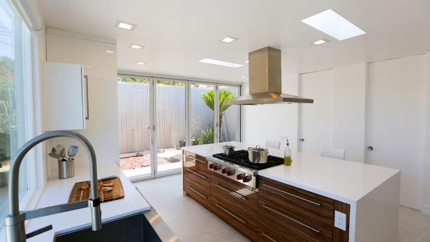 Large Kitchen Island Under Stainless Steel Range Hood With Built