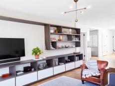 Long Modern Shelving Creating Stylish Entertainment Center in Bright Living Room With Brown Leather Armchair 