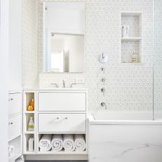 Pattern Wall Tile in Bright, White Bathroom With Marble Bathtub and Gray Floor Tile 