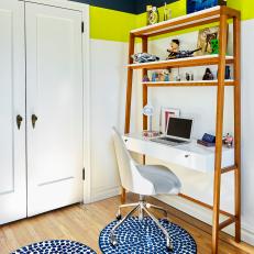 Wood-Framed Kid's Desk Over Thick Wall Stripes, Rolling Modern Desk Chair and Navy Polka Dot Rugs 
