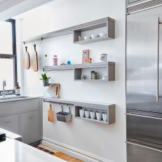 Gray Floating Shelves With Hanging Racks and Cubby Storage in Bright, Modern Kitchen 