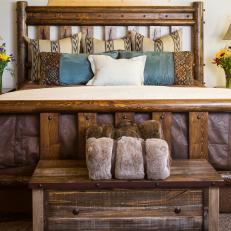 Rustic Bedroom With Thick Wood Bed Frame, Decorative Throw Pillows and Wood Chest 