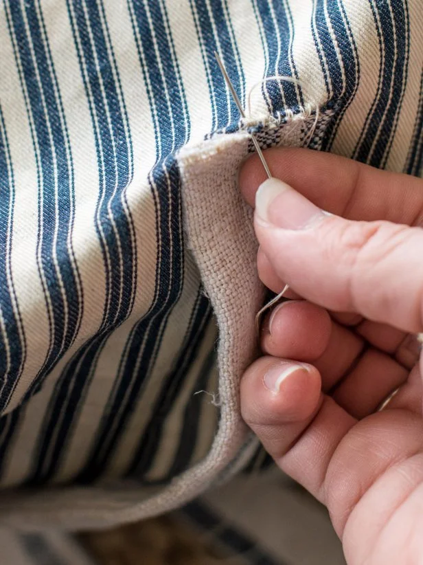 Hand-stitch ties (or ribbons) onto desired locations on top and bottom side of dog bed, so both sets of ties are symmetrical and line up when tied.