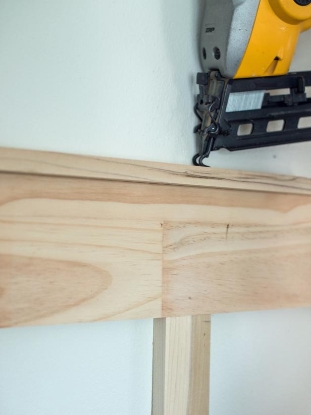 Cut 1” x 2” pine board to proper measurement on chop/miter saw.  Rest on top of horizontal top rail to create a ledge.  Nail into place, downward into top rail.