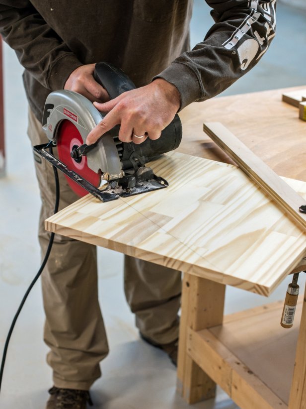 Cut wood to sizes in supplies list either at home or at hardware store.  Take one 16” square piece and measure and mark angle to match diagram.  Cut marked line with a circular saw.  Use first cut piece as a template for the other three.  Mark and cut remaining three pieces.  Tip: Clamp wood piece to stable work surface while cutting with the circular saw to prevent it from shifting.