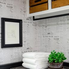 Renovated Laundry Room With Newspaper-Style Wallpaper and Crate Storage