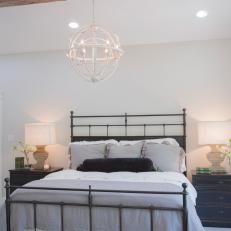 Renovated Master Bedroom With Exposed Beam Ceiling and Globe Chandelier 