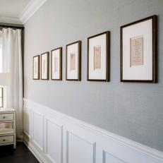 Gray Wall With Row of Artwork