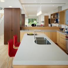 Midcentury Open Plan Kitchen With Red Chairs