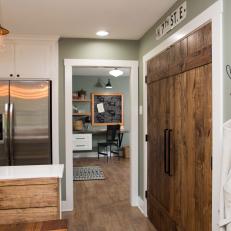Natural Wood Kitchen Pantry Doors Framed With White Molding in Seafoam Green Wall 