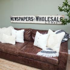 Brown Leather Living Room Sofa With Cream Throw Pillows 