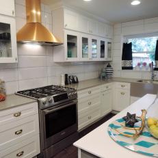 Extra Large White Tile Backsplash in Traditional Kitchen With Polished Gold Range Hood, Glass Door Cabinets and Island