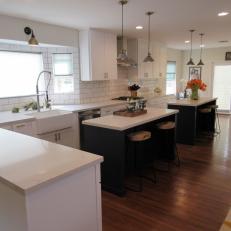 Double Island Kitchen With White Subway Tile Backsplash, Sleek White Countertop and Natural Wood Barstools 