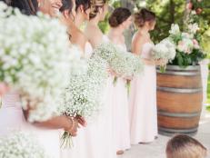 Bridesmaids Wearing Pink Dresses Holding Baby's Breath Bouquets