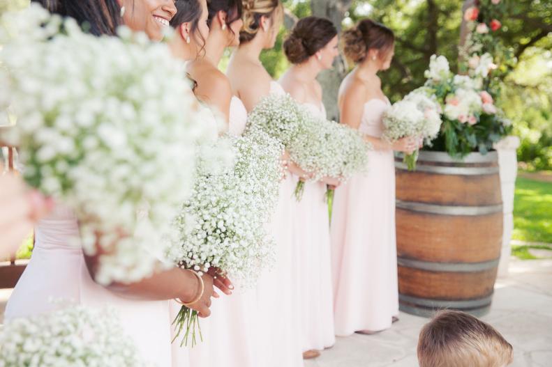 Bridesmaids Wearing Pink Dresses Holding Baby's Breath Bouquets