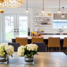 Bright Eat In Kitchen and Dining Room Featuring Gray and White Backsplash, Mustard Yellow Bar Chairs and Hydrangea Bouquets