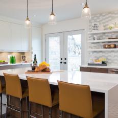 Long Eat In Kitchen Island With Mustard Yellow Bar Chairs and Trio Of Pendant Lights 
