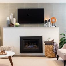Smooth White Fireplace Surround with Decorated Mantel, Basket Storage and Cube Floor Cushion
