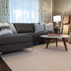 Gray-Brown Sectional Decorated With a Mix of Gray Patterned Throw Pillows 