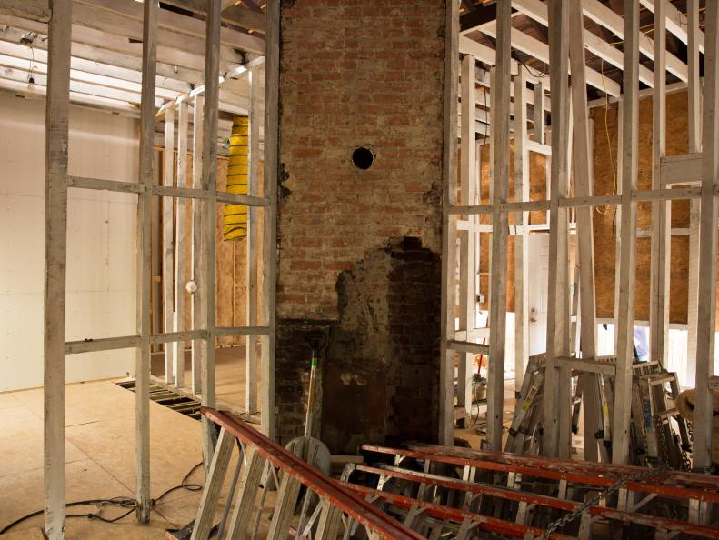 The guest bedroom of Drew Scott's side of a typical New Orleans shotgun style house before renovations, as seen on Brothers Take New Orleans. (Before #1)