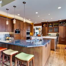 Brown Open Plan Kitchen With Multicolored Stools