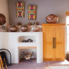 Southwestern Fireplace With Large Tile Hearth Under White Mantel Shelves Filled With Pottery
