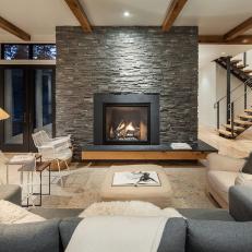 Contemporary Living Room With Large, Gray Rock Fireplace Surround and Neutral Furniture 