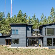 Charcoal Gray Siding on Modern Home With Open Patio and Second Floor Balcony 