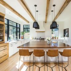Large Eat-In Kitchen Island Under Black Bucket Pendant Lights and Exposed Wood Beams 