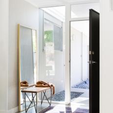 Modern Home Entry With Black Front Door, Large Window Door Frame and Colorful Rug 