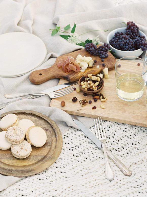 Fruit, Meat and Cheese Picnic Spread on a White Blanket