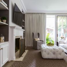 Neutral Transitional Sitting Room With White Ottoman