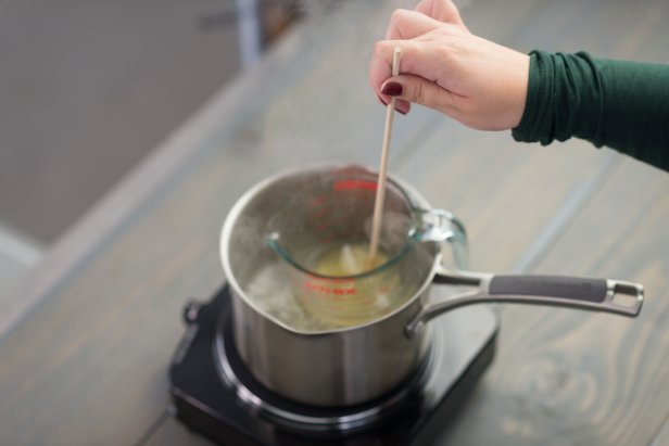 Stir wax flakes with a wooden dowel until completely liquefied – about 180 degrees F.