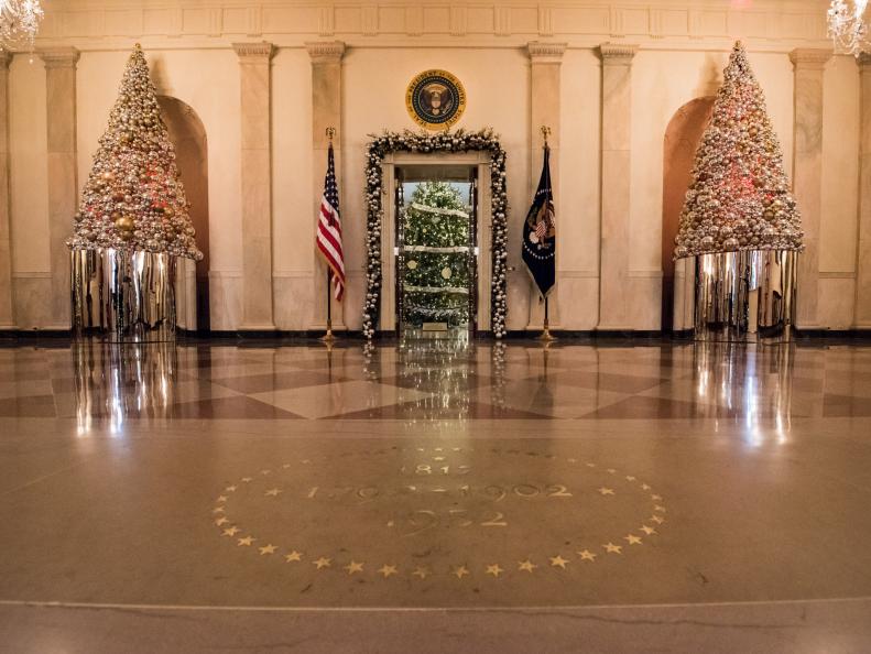 As seen on HGTV's White House Christmas 2016, the Grand Foyer and Cross Hall serve as the setting for The Gift of Reflection. Next to stacked columns of shiny presents, mirrored ornaments will adorn the trees and garlands, reflecting the hope and gratitude in each visitor. This year’s holiday theme, “The Gift of the Holidays,” reflects on not only the joy of giving and receiving, but also the true gifts of life, such as service, friends and family, education, and good health, as we celebrate the holiday season.