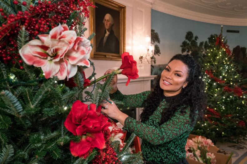 As seen on HGTV's White House Christmas 2016, host Egypt Sherrod, places a red flower in a Christmas tree in the Diplomatic Reception Room of the White House. The Diplomatic Reception Room serves as an entrance to the White House from South Grounds for the family and for ambassadors arriving to present their credentials to the President. This year’s holiday theme, “The Gift of the Holidays,” reflects on not only the joy of giving and receiving, but also the true gifts of life, such as service, friends and family, education, and good health, as we celebrate the holiday season.