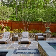 Lounge Area Nestled Around Hot Tub in Small Backyard