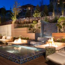 Modern Outdoor Lounge Area With Water Feature and Fire Pits